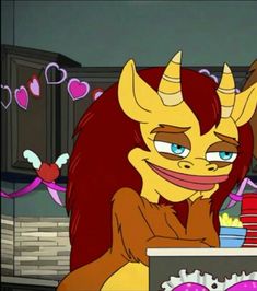 an animated image of a woman with horns sitting at a table in front of a cake