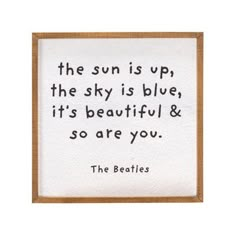 the beatles quote on white paper with brown frame