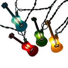 four guitars are hanging from a string with lights on it's ends and strings attached to them