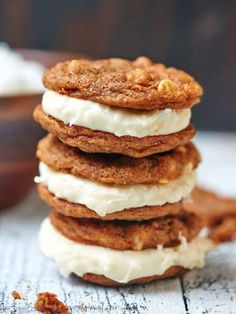 three cookies stacked on top of each other with white frosting and walnuts around them