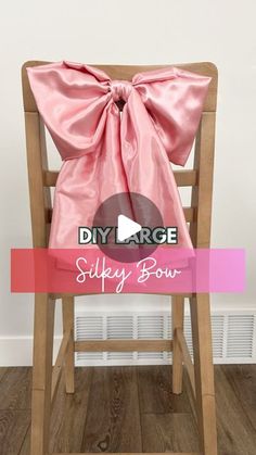 a pink bow sitting on top of a wooden chair with the words diy large