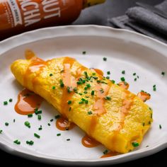 an omelet on a white plate with condiments