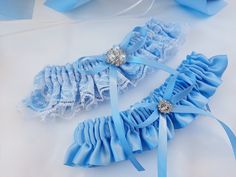 "Blue Garter, Wedding Garter Blue, Garter Set, Blue Bridal Garter, Wedding Garter Set, Blue Garter Set, Garters For Wedding, Garter Belt Beautiful wedding set! Made of ice blue satin, light blue ribbons and bows, white lace and beautiful brooches. * Base color can be changed to White instead of ice blue as on picture (specifically white satin fabric). To request the base color change, just mention it in the \"note to seller\" box at the checkout. Please, choose your accessories in a drop down me Blue Garter Wedding, Garters For Wedding, Blue Bridal Garter, White Satin Fabric, Wedding Garter Blue, Light Blue Ribbon, Garter Wedding, Blue Garter, Cake Serving Set