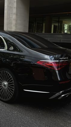 a black car parked in front of a building