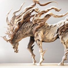 a sculpture of a horse with long hair on it's back legs and tail