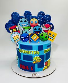 there is a blue cake decorated with cartoon characters