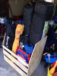 a wooden crate filled with lots of different types of items in it's storage area