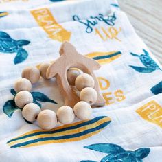 a wooden bead necklace on a towel with an ornament in the middle