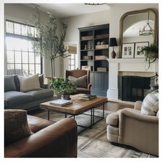 a living room with couches, chairs and a coffee table in front of a fireplace