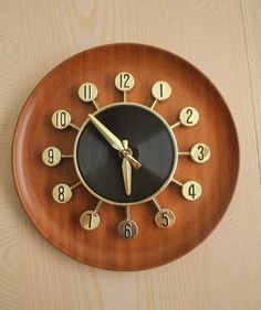 a wooden clock with numbers on the face