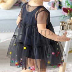 This layered tulle dress with fluttering flounces is a synonym to airness and tenderness in which your baby girl will look impressive! Dozens of candy-colored pom-poms will catch the eye on this fairy outfit and give it a little bit more sweetness! The lower layer plain dress is made of 80% cotton and 20% elastane and the upper is made of delicate soft tulle for best comfort!Pom-poms are not sewn inside for lightness! The color of pom-poms can be changed upon request! If you have your own idea a Black Dress Kids, Tulle Baby Dress, Black Tulle Dress, Kids Dress Wear, 파티 드레스, Girl Dress Patterns