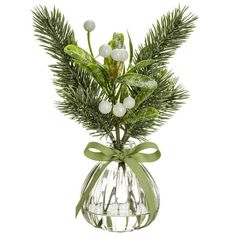 a glass vase filled with white flowers and greenery