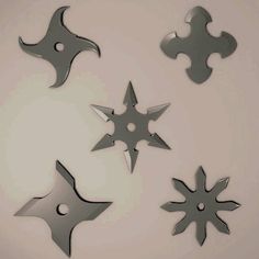 four metal objects are arranged in the shape of stars