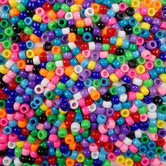 multicolored beads are scattered on a white surface