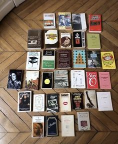 there are many books laid out on the floor next to each other in this photo