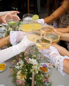 a group of people sitting around a table with drinks