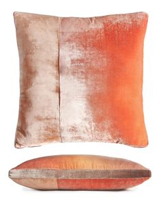 an orange and brown pillow sitting next to each other