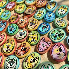 many colorful buttons with cats painted on them