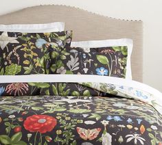 an image of a bed with flowers and butterflies on the comforter set in black