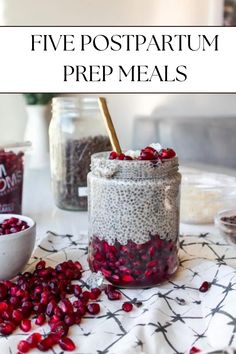 a jar filled with pomegranate next to two bowls and spoons on a table