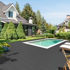 an outdoor swimming pool surrounded by greenery and shrubs in front of a large house