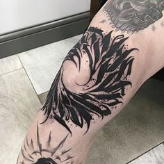 a man's leg with black ink on it and an eagle tattoo design in the middle