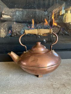 Romantic Colonial style Copper Horizontal Cloud Shape Tea Kettle Pot, featuring an arts and crafts squat type belly with a lovely hand hammered spout and a wood handle.  Very attractive streamlined design around the belly.  It is Signed Gregorian and the words Solid Copper Made in the U.S.A. on the base.  Perfect for your kitchen use or display. Condition: Very good vintage condition.  The kettle has a nice patina, there are spots of wear and age.  Two dings [please see photos] The inside shows Copper Teapot, Vintage Tea Kettle, Cloud Shape, Tea Lovers Gift, Cloud Shapes, Streamlined Design, Antique Wood, Tea Makers, Tea Lovers