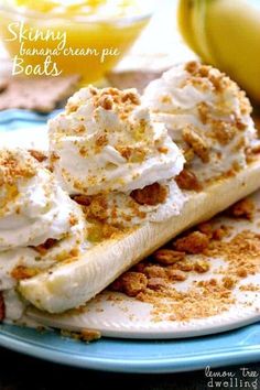 two banana slices with whipped cream and nuts on top are sitting on a blue plate