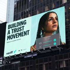 a large billboard on the side of a building with a woman's face and words