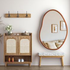 a living room with a wooden cabinet, mirror and plant on the wall next to it