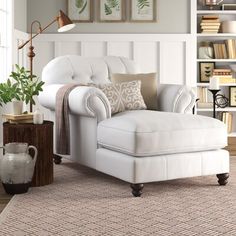 a white chair and ottoman in a living room