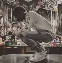 a man sitting on top of a metal table