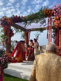 a couple getting married in front of an outdoor ceremony