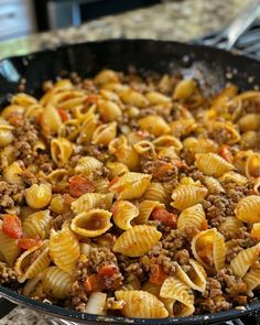 a skillet filled with pasta and ground beef