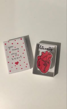 two valentine's day cards in boxes on a white surface with the words you have my heart printed on them