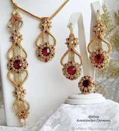 a necklace and earring set with red stones