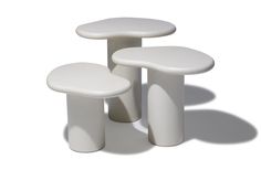 three white tables and stools sitting side by side on a white surface with shadows