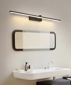 a bathroom with a sink and mirror on the wall