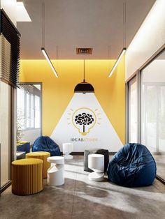 an office with yellow walls and blue bean bag chairs