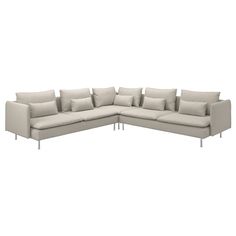 a white sectional couch with pillows on it's back and arms, viewed from the front