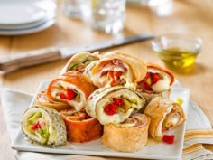 a white plate topped with lots of different types of food on top of a wooden table