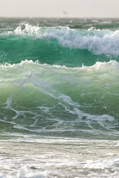 a man riding a wave on top of a surfboard