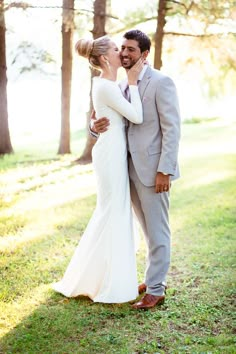 a man and woman kissing in front of trees with the caption family style weekend wedding