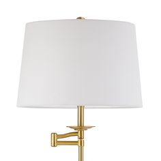 a gold lamp with a white shade on the base and a light bulb attached to it