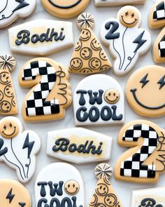 decorated cookies are arranged in the shape of christmas trees, lightning and two cool faces