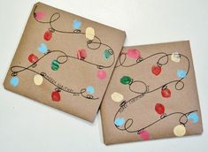 two brown paper plates with christmas lights on them