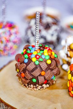 there are many cupcakes on the table with candies and other treats around them