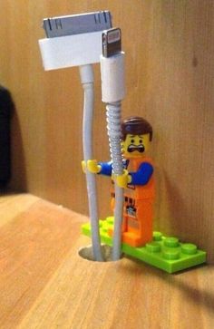 a lego man standing next to a toothbrush holder