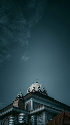 the top of a building with a bird on it's roof and sky in the background