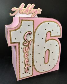 a pink and white birthday card with the number sixteen on it